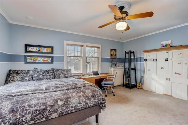 carpeted bedroom featuring ceiling fan and ornamental molding