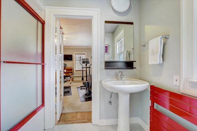 bathroom with a sink and baseboards