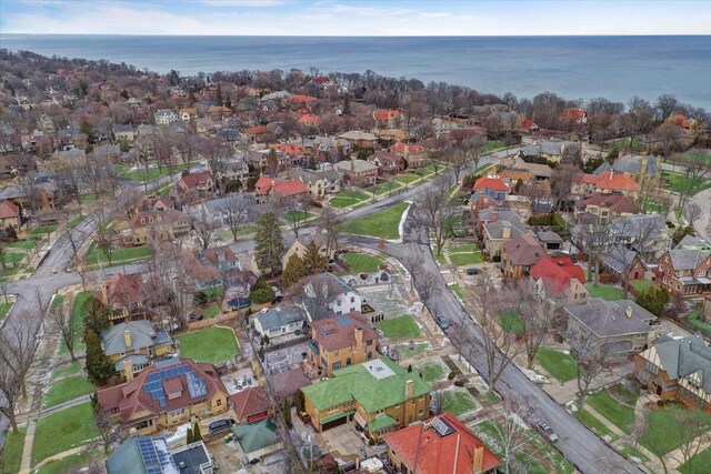 drone / aerial view with a water view and a residential view