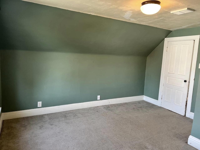 bonus room with lofted ceiling, visible vents, baseboards, and carpet floors