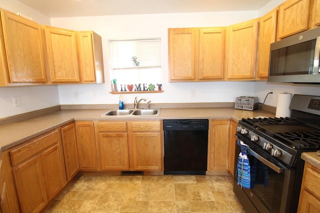 kitchen with appliances with stainless steel finishes, light countertops, a sink, and visible vents