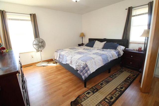 bedroom featuring baseboards and wood finished floors