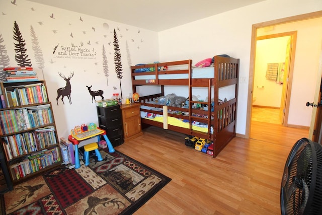 bedroom with wood finished floors and baseboards