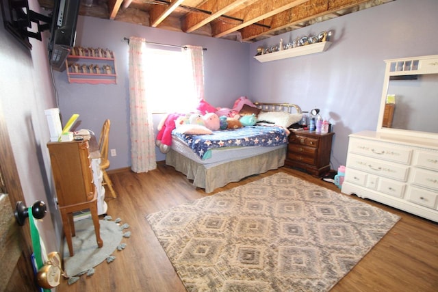 bedroom with wood finished floors