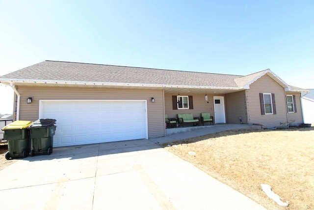 ranch-style home with driveway, roof with shingles, and an attached garage