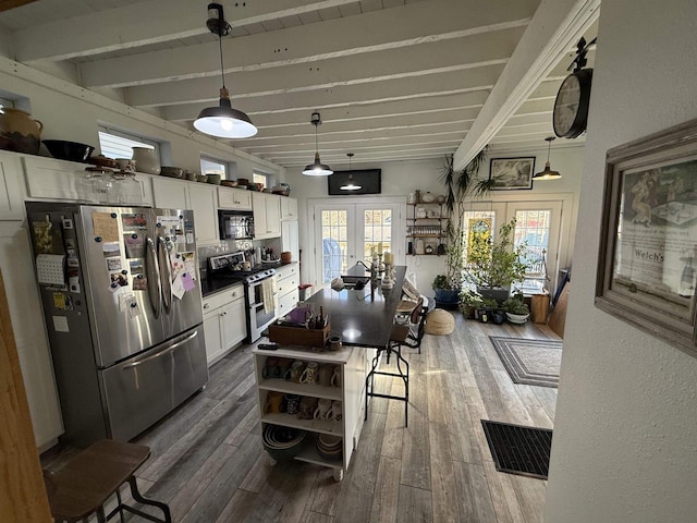 kitchen with stainless steel appliances, french doors, a healthy amount of sunlight, and white cabinets