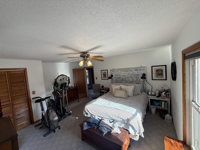 bedroom with carpet floors, ceiling fan, a closet, and a textured ceiling