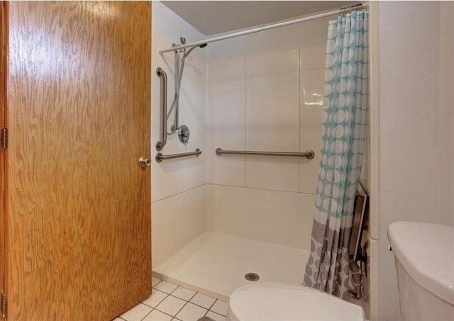 full bathroom with tile patterned flooring, a stall shower, and toilet