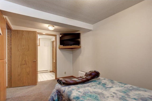 bedroom with baseboard heating, carpet floors, and a textured ceiling