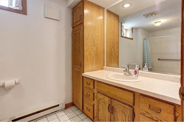 full bath featuring tile patterned flooring, a baseboard heating unit, baseboards, toilet, and vanity