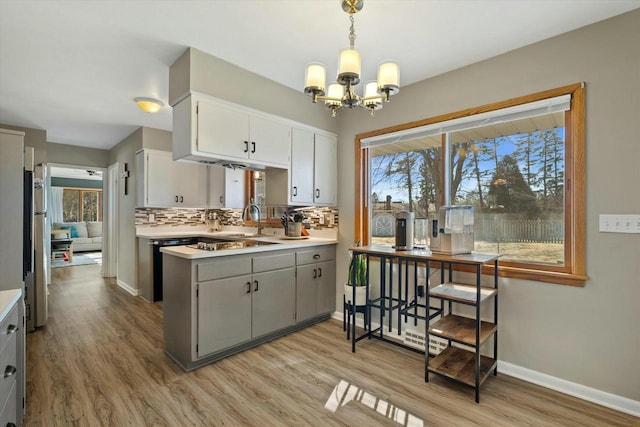 kitchen featuring backsplash, light countertops, and a healthy amount of sunlight