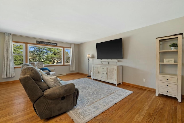 living area with wood finished floors, baseboards, and a baseboard radiator