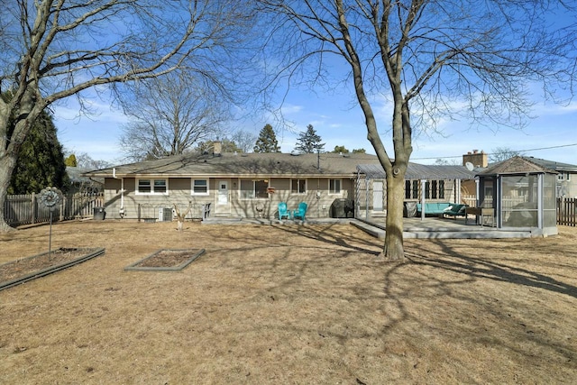 back of property featuring a patio and fence