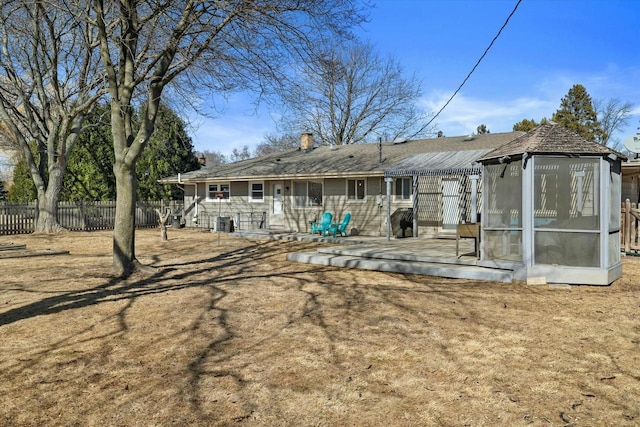 rear view of house featuring a patio and fence