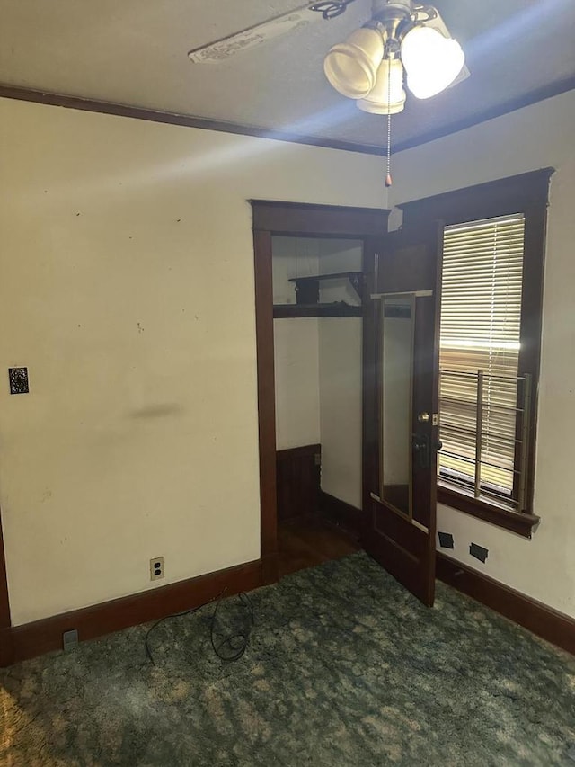 empty room featuring carpet flooring and baseboards