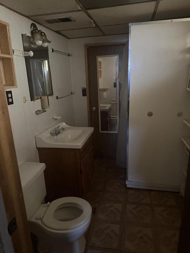 half bath featuring visible vents, vanity, and toilet