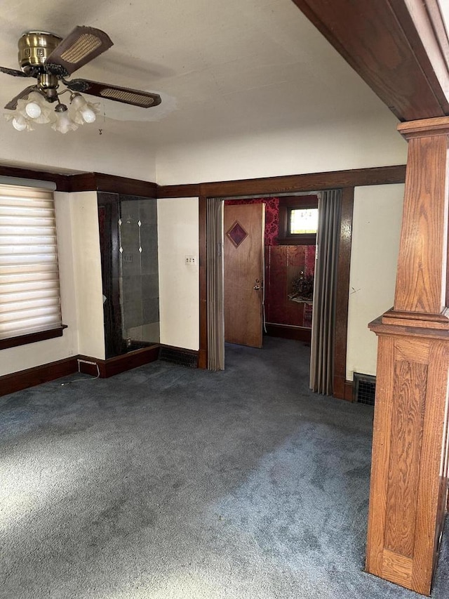 empty room with ceiling fan, carpet flooring, and visible vents