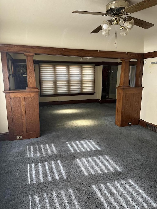 unfurnished living room featuring carpet floors, decorative columns, baseboards, and a ceiling fan