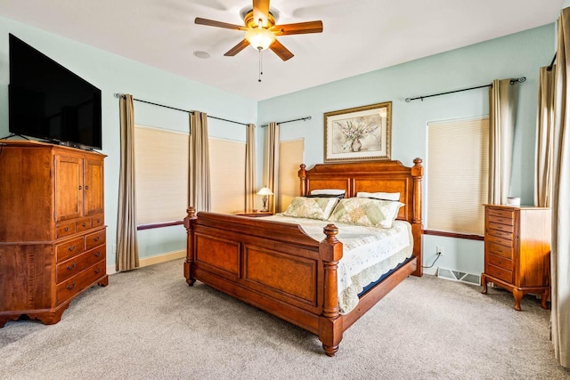 bedroom featuring ceiling fan, baseboards, and light carpet