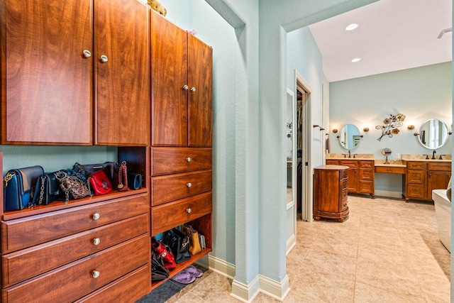 interior space with tile patterned flooring, recessed lighting, vanity, and baseboards