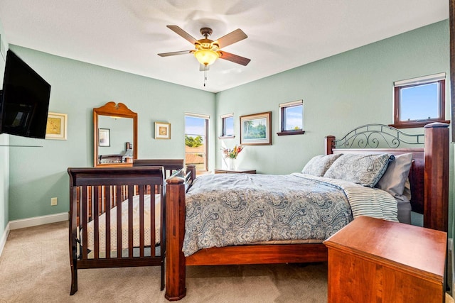 carpeted bedroom with a ceiling fan and baseboards