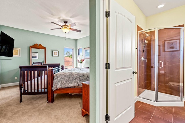 bedroom featuring baseboards, carpet floors, a ceiling fan, and tile patterned flooring