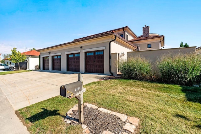 view of front of house featuring stucco siding, a chimney, concrete driveway, and a front lawn