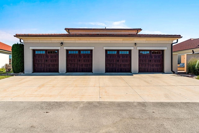 garage with concrete driveway