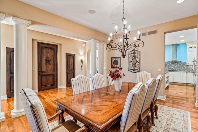 dining area with visible vents, light wood-style floors, baseboards, and ornate columns