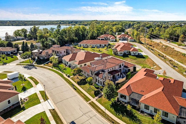 drone / aerial view featuring a water view and a residential view