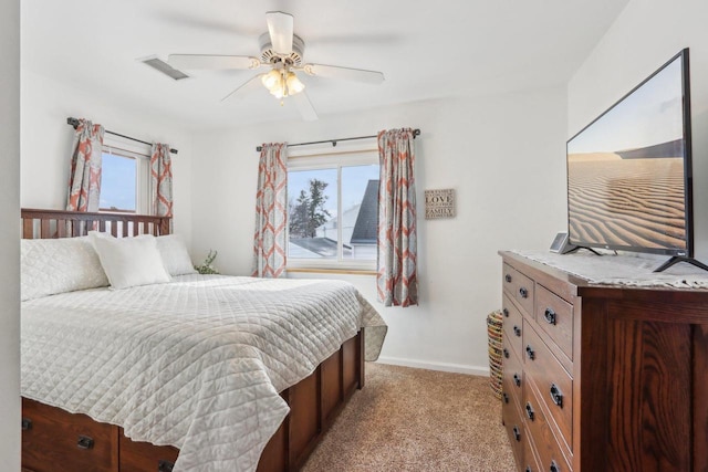 bedroom featuring baseboards, ceiling fan, visible vents, and light colored carpet