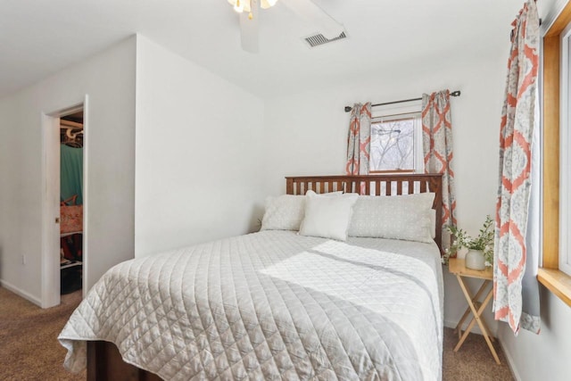 bedroom featuring a ceiling fan, carpet flooring, visible vents, and baseboards