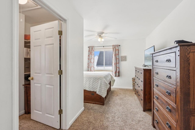 bedroom featuring light carpet, attic access, and baseboards