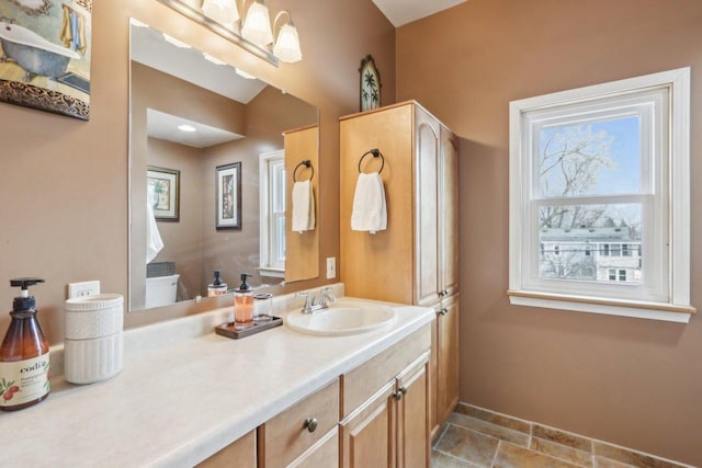 bathroom featuring tile patterned flooring, vanity, and baseboards