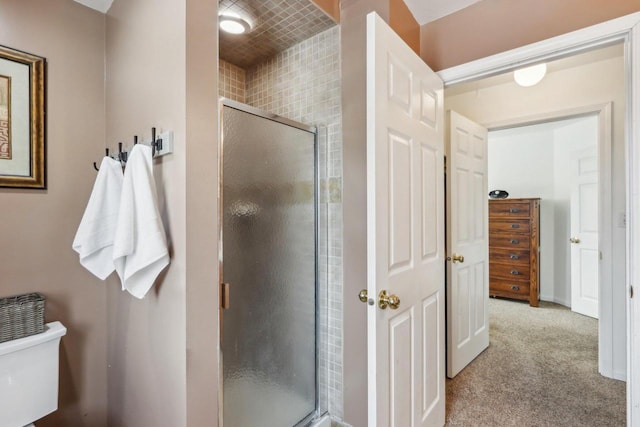 full bath featuring a stall shower and toilet