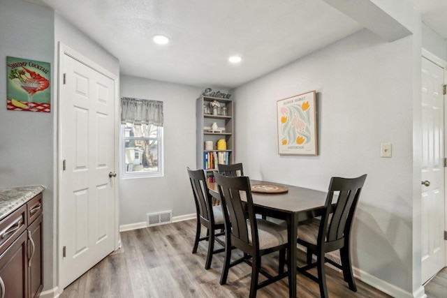 dining area featuring recessed lighting, wood finished floors, visible vents, and baseboards