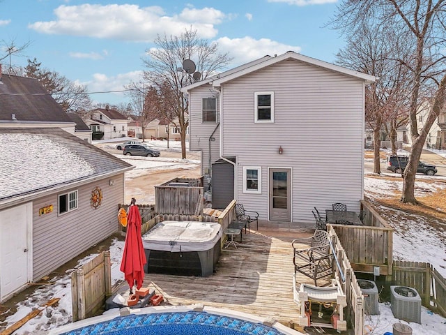 rear view of property with central AC, a wooden deck, and fence