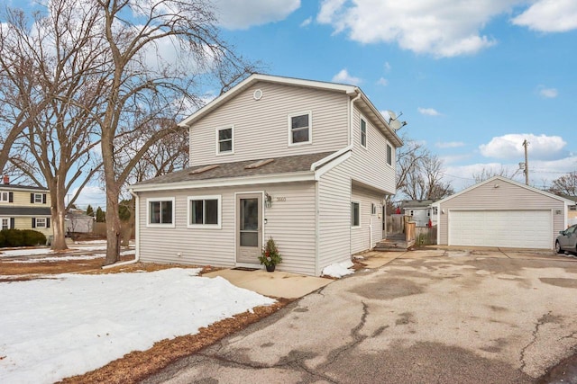 view of front facade featuring a garage and an outdoor structure