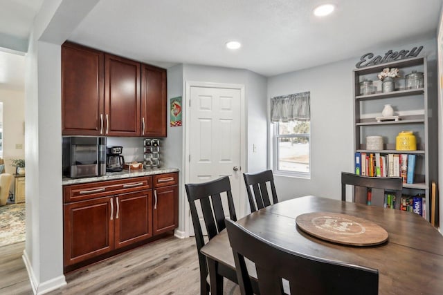 dining space featuring light wood finished floors and recessed lighting