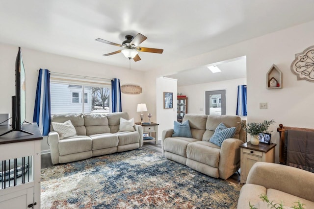 living room with ceiling fan and wood finished floors