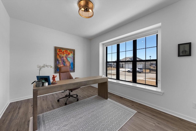 office area with baseboards and wood finished floors