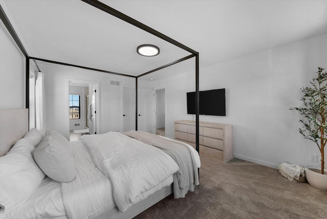 bedroom with baseboards, visible vents, carpet flooring, and ensuite bathroom