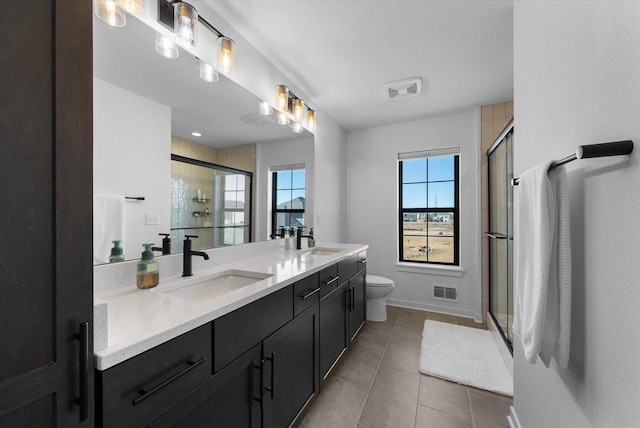 full bath featuring a stall shower, a sink, and visible vents