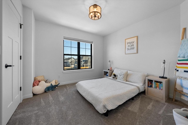 bedroom with carpet floors and baseboards