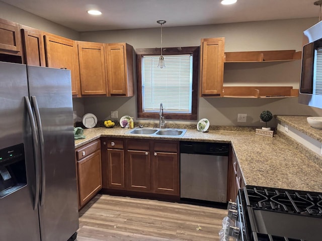 kitchen featuring recessed lighting, stainless steel appliances, a sink, light wood-style floors, and open shelves