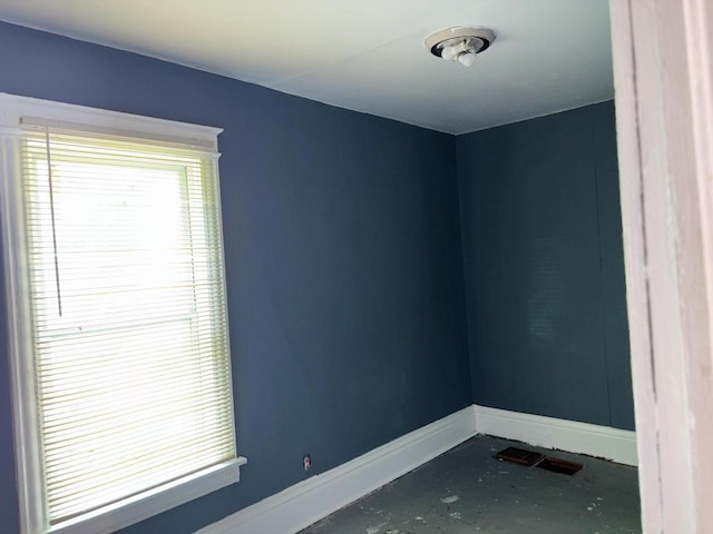 spare room featuring visible vents and baseboards