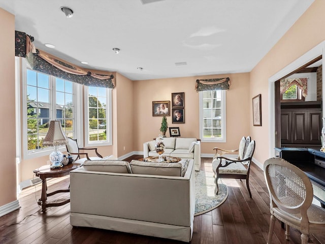 living room with a wealth of natural light, baseboards, and dark wood-style flooring