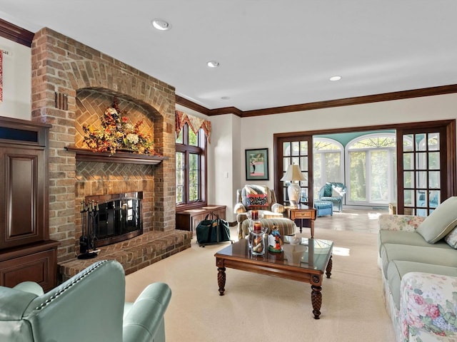 carpeted living room featuring ornamental molding, recessed lighting, a healthy amount of sunlight, and a fireplace