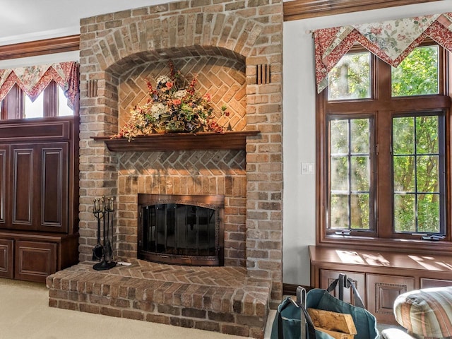 living area featuring carpet and a fireplace