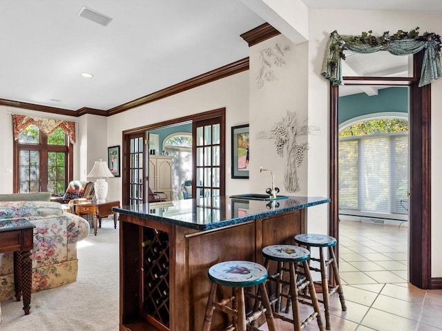 bar with crown molding, light tile patterned floors, recessed lighting, light carpet, and a sink